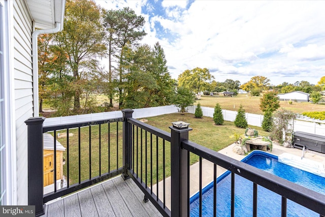 wooden terrace with a yard and a fenced in pool