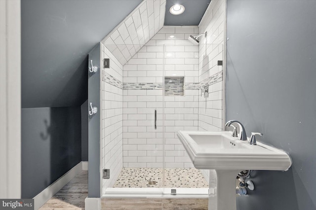 bathroom featuring hardwood / wood-style flooring and an enclosed shower