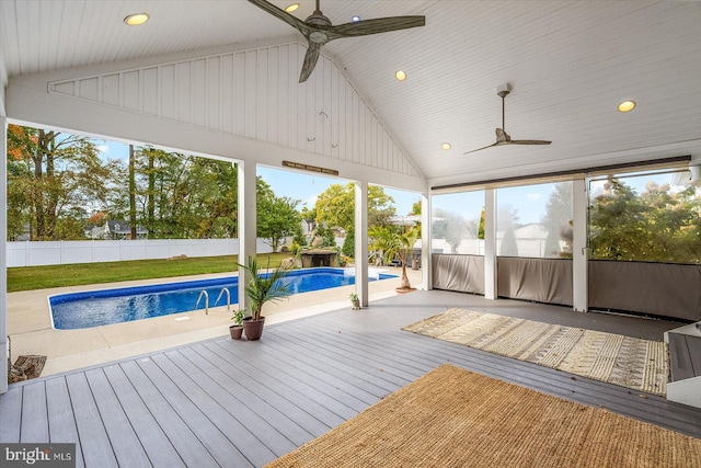 unfurnished sunroom with a pool, lofted ceiling, ceiling fan, and plenty of natural light