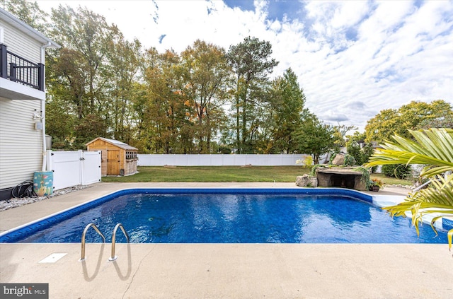 view of pool with a yard, a storage shed, and a patio