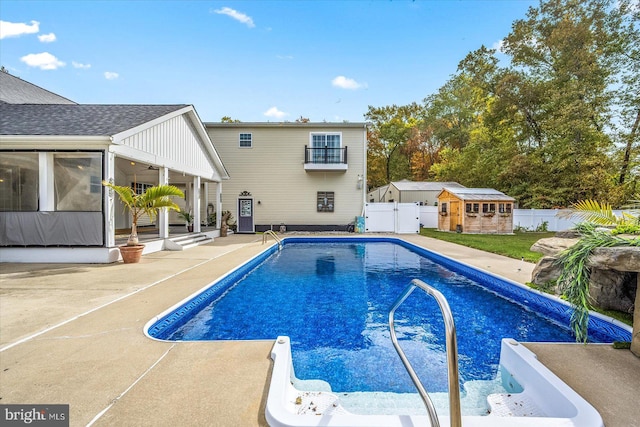 view of pool with a patio area and an outbuilding