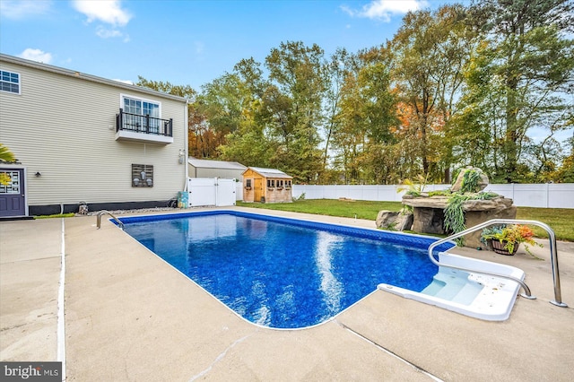 view of swimming pool featuring a patio area and a lawn