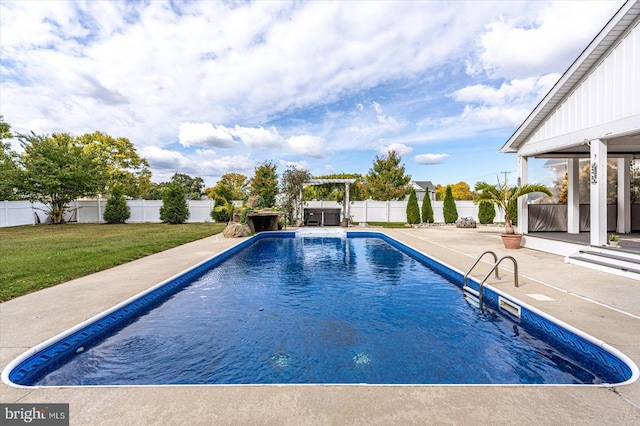 view of pool with a patio and a lawn