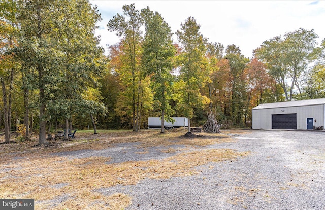 view of yard featuring an outbuilding and a garage