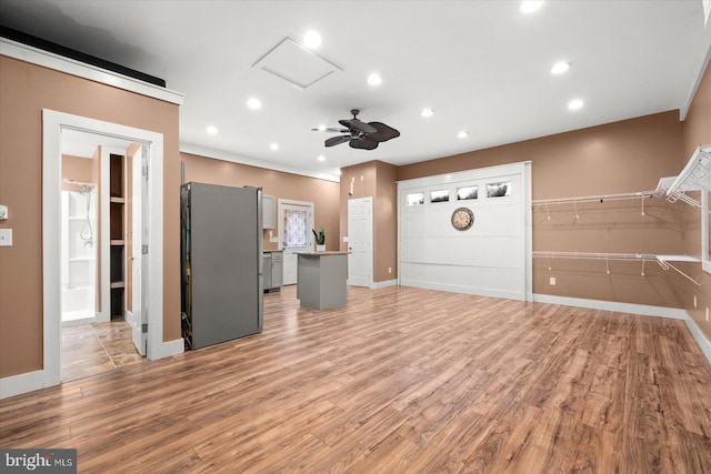 unfurnished living room featuring light hardwood / wood-style flooring and ceiling fan