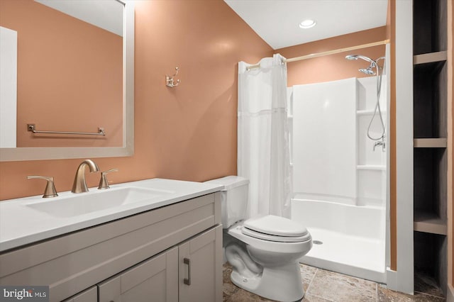 bathroom with vanity, curtained shower, and toilet