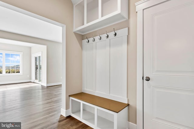 mudroom with wood finished floors and baseboards