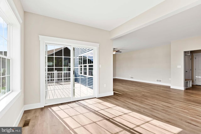 empty room with ceiling fan and wood-type flooring