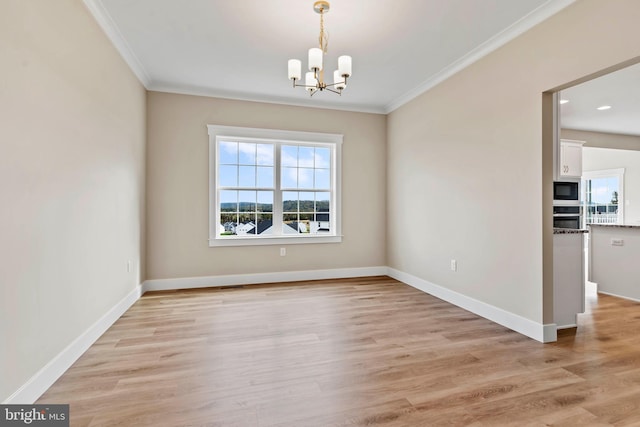 unfurnished dining area featuring ornamental molding, a notable chandelier, and light wood-style flooring