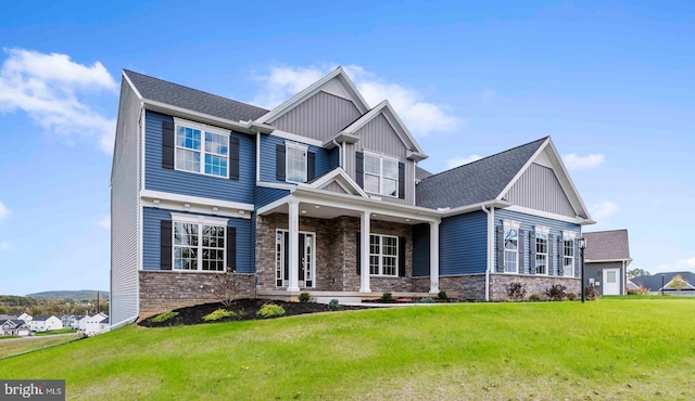 craftsman-style house with a front lawn, stone siding, and board and batten siding