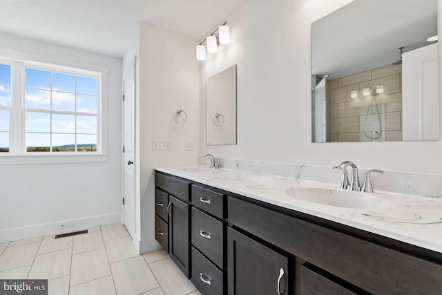 bathroom with vanity, a shower, and tile patterned floors