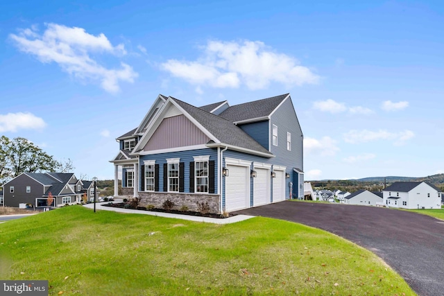 view of home's exterior featuring stone siding, aphalt driveway, a yard, and a garage