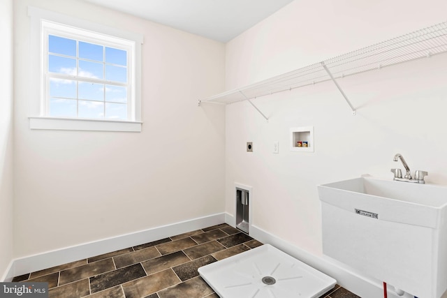 washroom featuring a sink, hookup for an electric dryer, baseboards, laundry area, and washer hookup