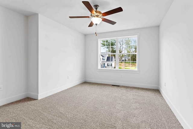 empty room with carpet flooring, baseboards, and ceiling fan