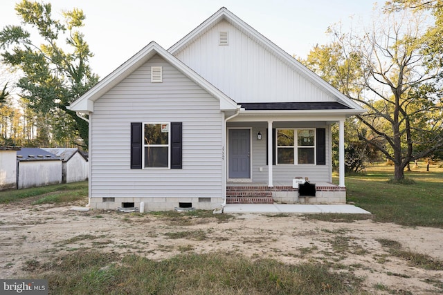 view of front of property with a front yard and a porch