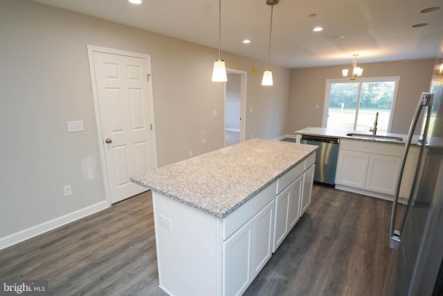 kitchen featuring stainless steel appliances, hanging light fixtures, dark hardwood / wood-style floors, and white cabinets