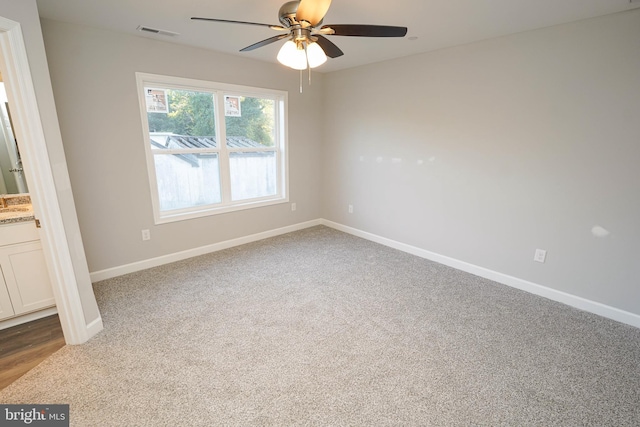 unfurnished room featuring ceiling fan and carpet floors