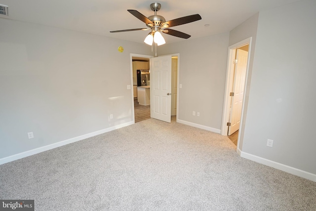 unfurnished bedroom featuring ceiling fan and light carpet