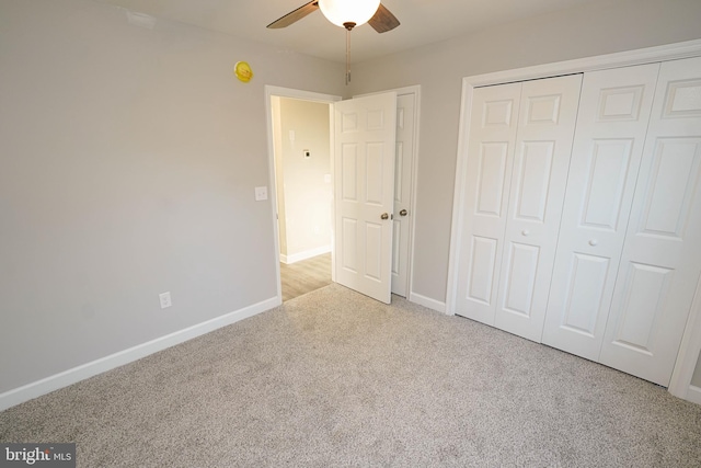 unfurnished bedroom with light colored carpet, a closet, and ceiling fan