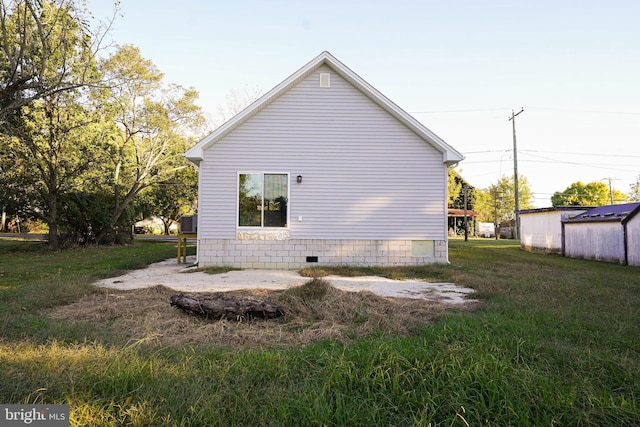 view of property exterior with a lawn