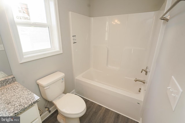 full bathroom with vanity, hardwood / wood-style flooring, toilet, and bathing tub / shower combination