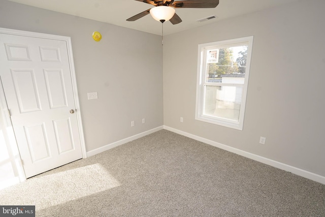 spare room featuring carpet floors and ceiling fan