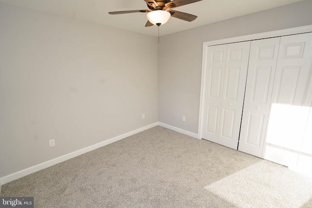 unfurnished bedroom featuring a closet, carpet floors, and ceiling fan