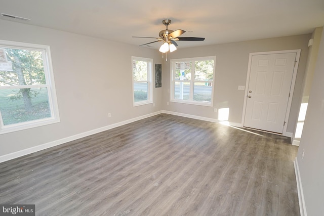 unfurnished room featuring hardwood / wood-style flooring, plenty of natural light, and ceiling fan