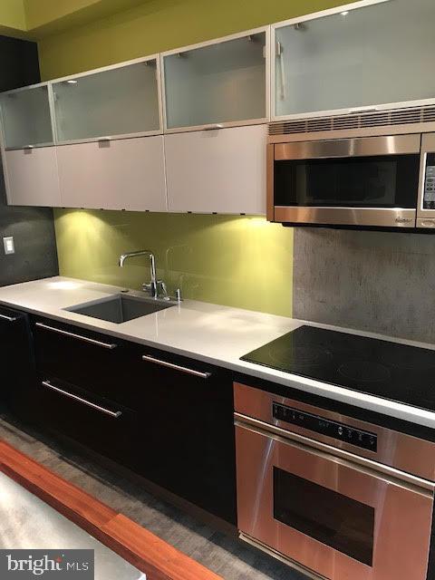 kitchen with white cabinetry, sink, and stainless steel appliances