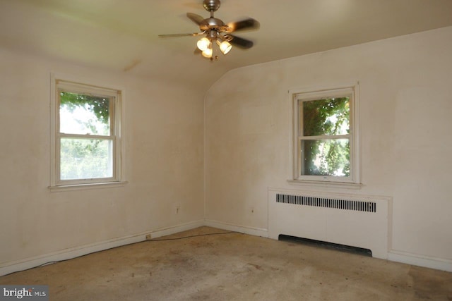 unfurnished room featuring plenty of natural light, light carpet, ceiling fan, and radiator