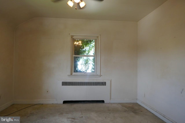 unfurnished room featuring ceiling fan and radiator