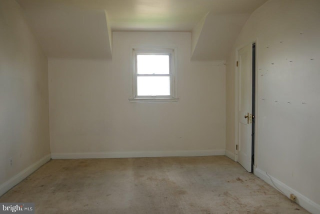 additional living space with lofted ceiling and light colored carpet