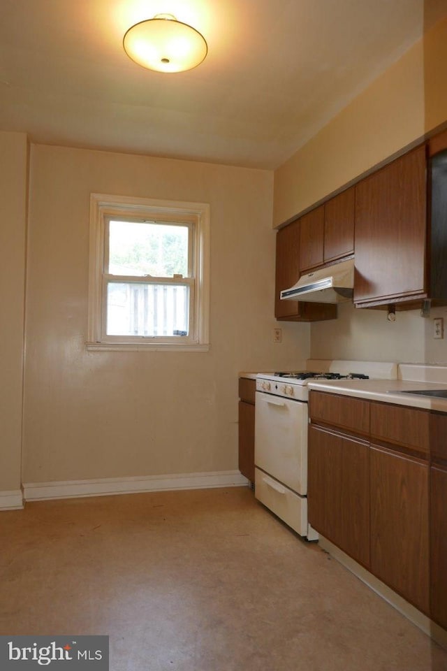 kitchen featuring white range with gas stovetop and sink