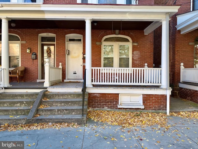 view of exterior entry featuring a porch