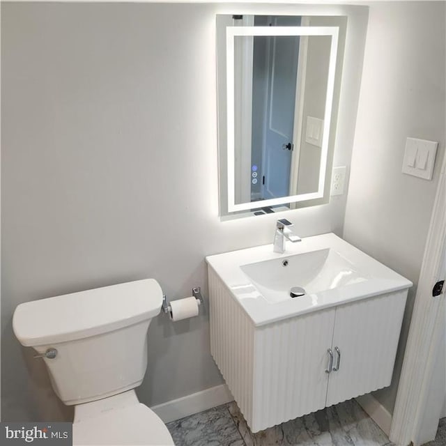 bathroom featuring toilet and vanity