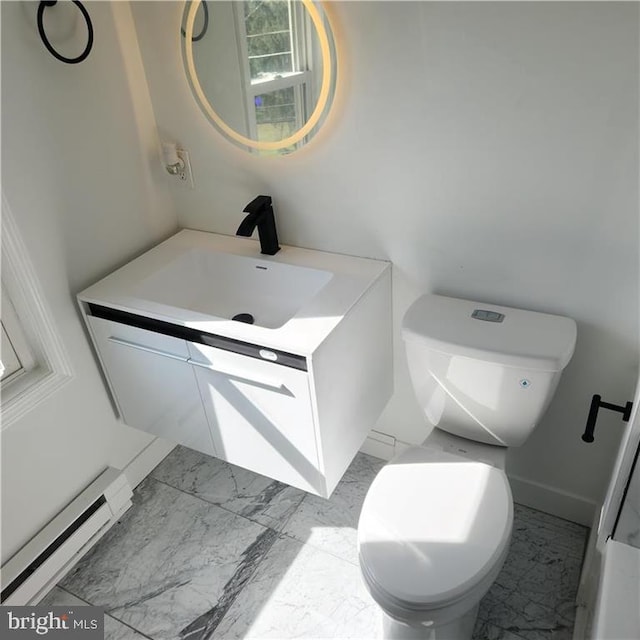 bathroom featuring baseboard heating, vanity, and toilet