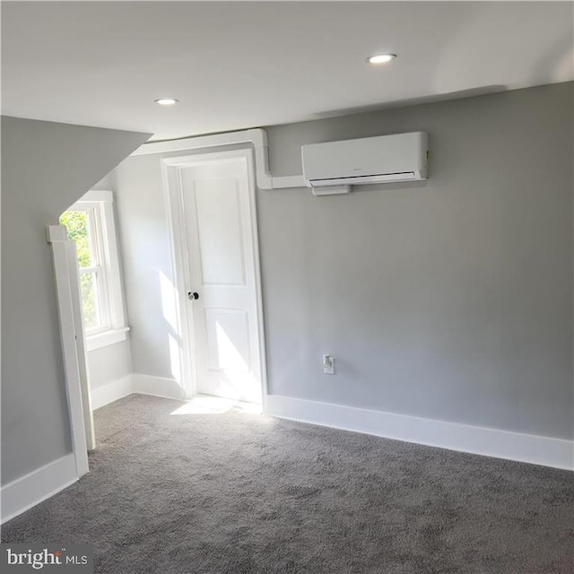 interior space featuring a wall unit AC and carpet flooring