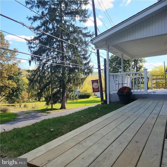 wooden deck with a lawn