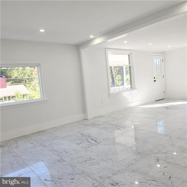 unfurnished room featuring plenty of natural light