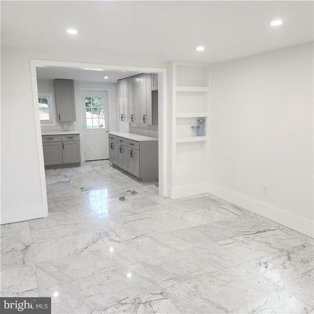 kitchen with gray cabinetry and built in features