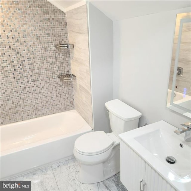 full bathroom with vanity, tiled shower / bath combo, and toilet