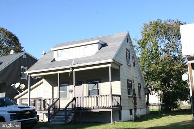 view of front of home featuring a front yard and a porch