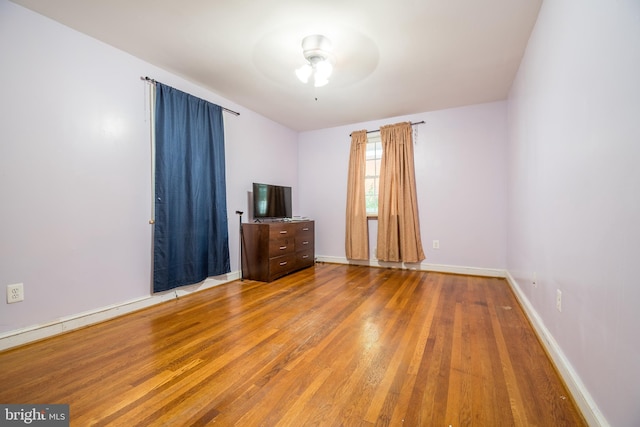 unfurnished bedroom featuring hardwood / wood-style flooring and ceiling fan