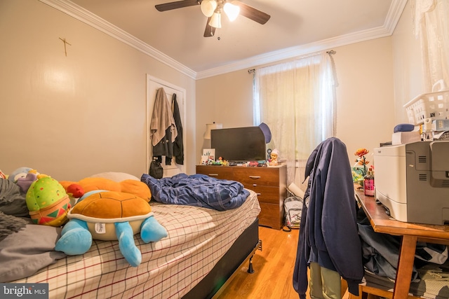 bedroom with ornamental molding, light wood-type flooring, and ceiling fan