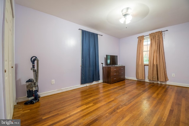 unfurnished bedroom featuring ceiling fan and hardwood / wood-style flooring