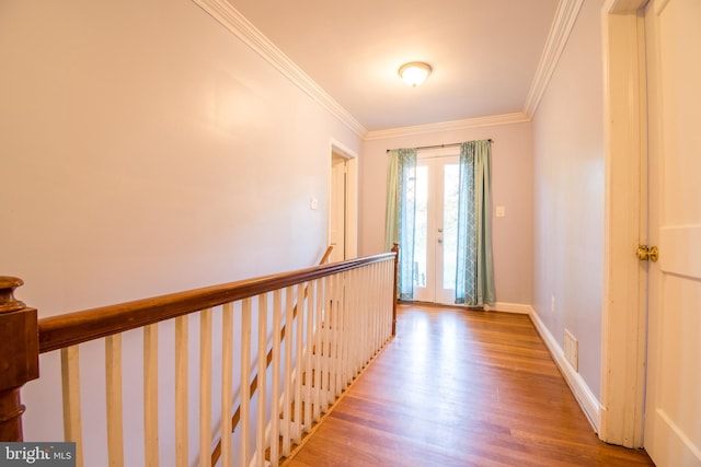 corridor with crown molding and light wood-type flooring