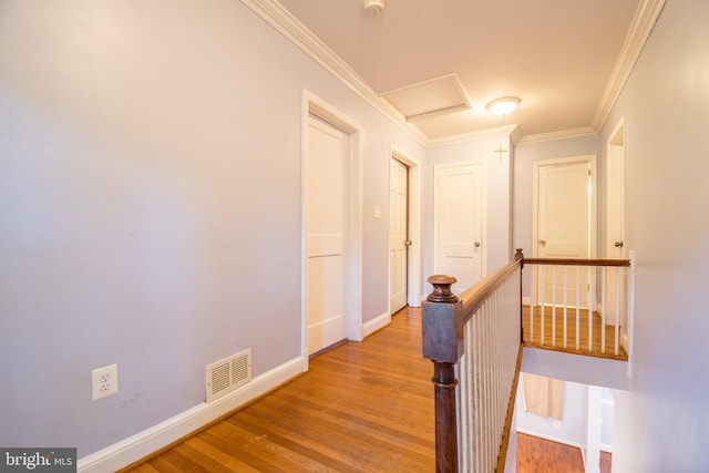 hallway featuring light hardwood / wood-style floors and crown molding