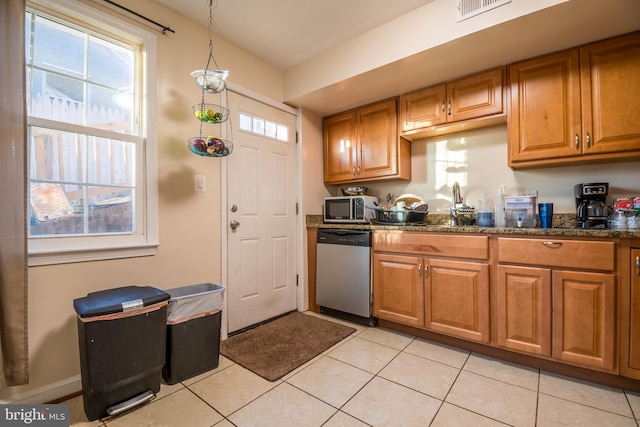 kitchen featuring light tile patterned floors, appliances with stainless steel finishes, and a wealth of natural light