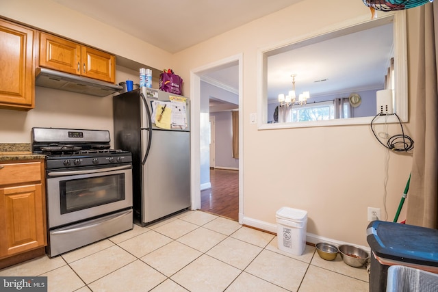 kitchen with stainless steel appliances, ornamental molding, light tile patterned floors, and a chandelier