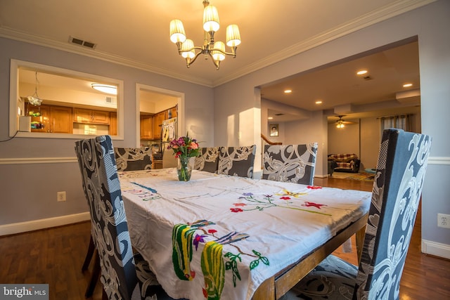 dining space with crown molding, dark wood-type flooring, and ceiling fan with notable chandelier